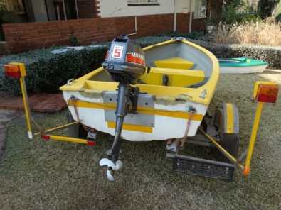 2.8 meter fibre glass boat on trailer with engine.