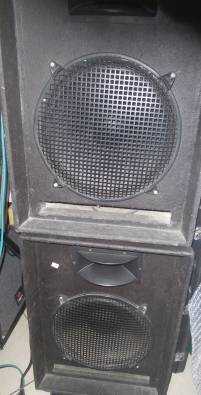 2x15 inch DJ speakers with steel legs.