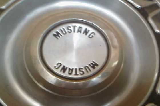 4 origional 1969 metal. ford mustang hubcaps.