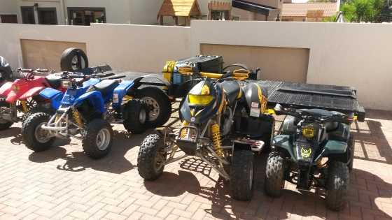 4 Quads on trailer with gear.