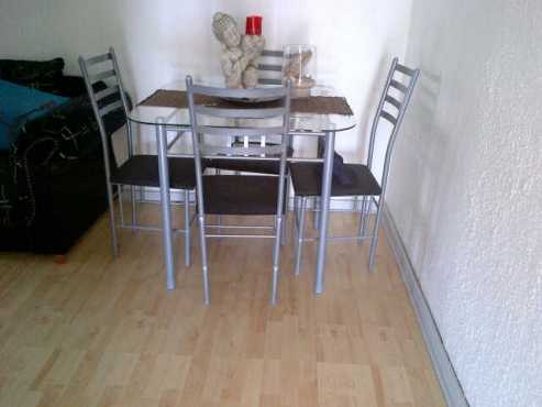 4 seater glass dinning table and chairs