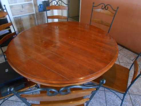 A Teach Round 6 seater dining room table with 6 chairs with Teach inlays