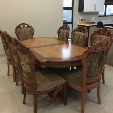 A vintage Italian wood dinning table with matching 8 chairs.