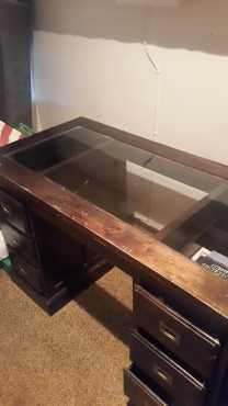 Antique desk with 6 drawers and inserted glass top