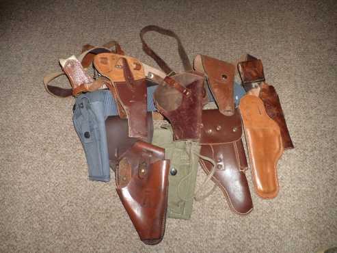 assorted holsters for pistols and revolvers