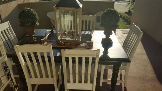 Black table with 6 white washed chairs for sale