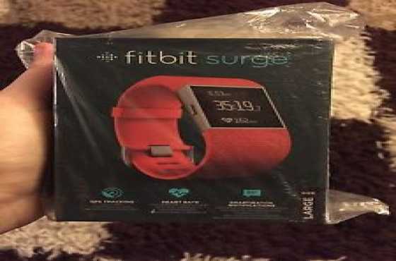 Brand new Sealed Red Fitbit Surge Watch in box with all accessories in box for sale...