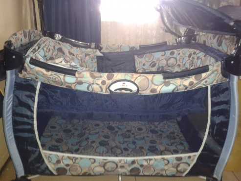 Camping cot with changing station and mattress