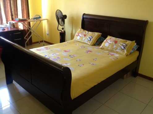 Deluxe wooden bed with mattress