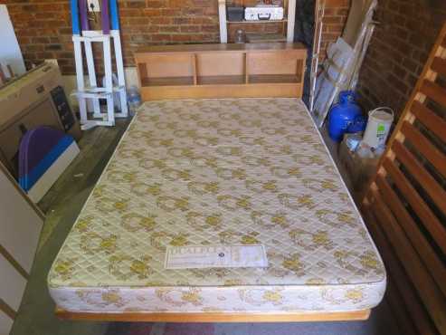 Double wooden bed with headboard and mattress