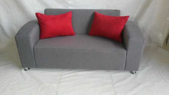 Grey couch with red cushions