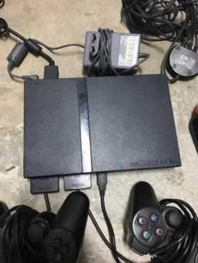 In Great Condition Latest Gen Super Slimline Playstation 2, with 2 Controllers amp 4 Buzz Remotes...