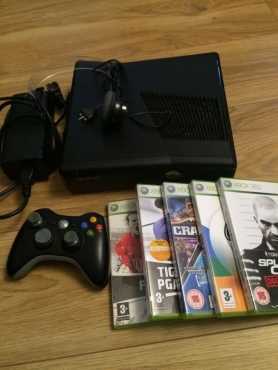 In mint condition black Xbox 360 slimline with 5 latest games and 1 wireless original controller, an