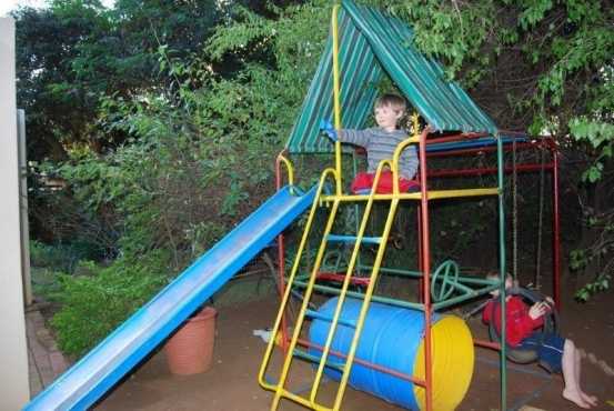 Kids steel framed jungle gym in good condition and trampoline