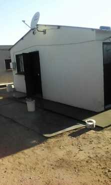 Orange Farm 2 bedrooms house with 3 outside rooms and a wall around for sale.