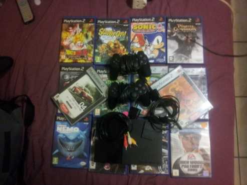 PlayStation 2 console 2 remotes 1 memory card and 14 original games