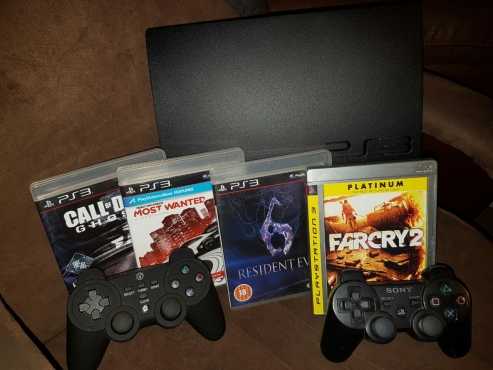 Playstation 3 with 4 games and 2 remotes