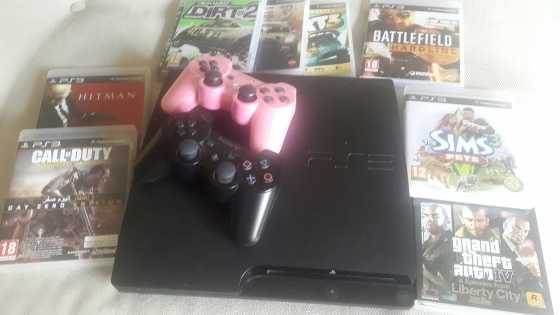 Playstation 3 with two wireless consols and 8 games.