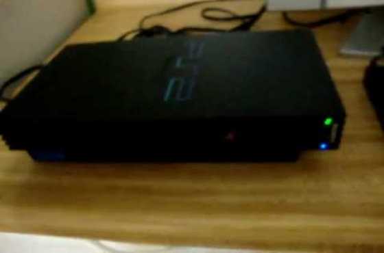 PS 2 CONSOLE(small)  2 Remotes and 4 ps2 games for sale