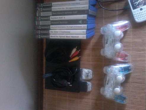 ps2 slim and 2 wireless remotes with 8 games and a memory card