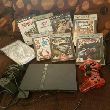 PS2 with 2 remotes and 8 games