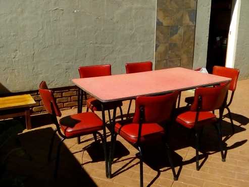 Red panelite dinner table with six matching chairs