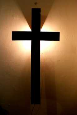 Rustic wooden cross wall light made from treated pallet hard wood.