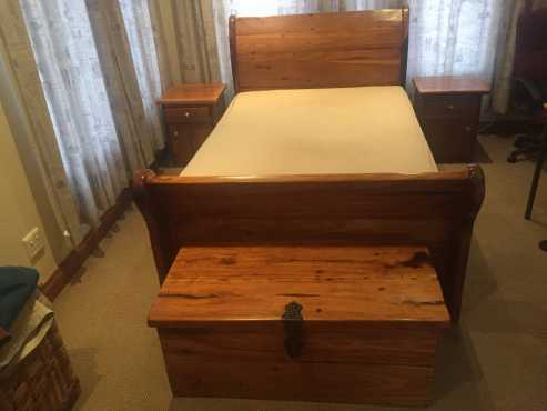 Solid sleeperwood bedset with two nightstands and a chest.