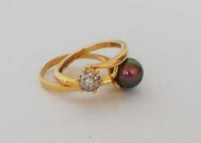 Two Gold Rings with Diamonds and a black Pearl