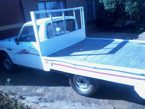 white 1980 isuzu kb20 flatbed.