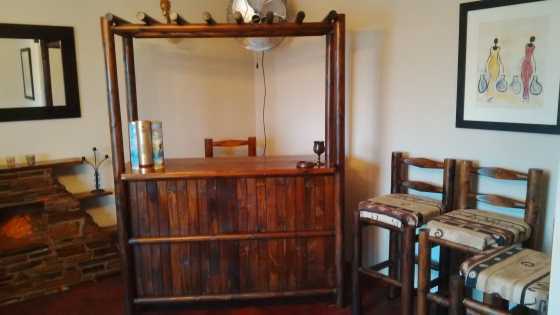 Wooden bar with 4 bar chairs.