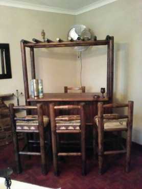 Wooden bar with 4 bar chairs.