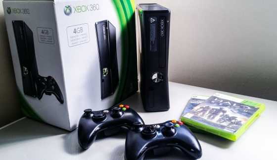 Xbox 360 Slim with controllers and games