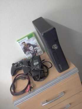 Xbox 360 with a remote control and HDMI cable