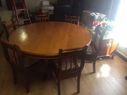 Yellow and Imbuia wooden dining room dining room round table, 6 chairs and Welsh dresser.